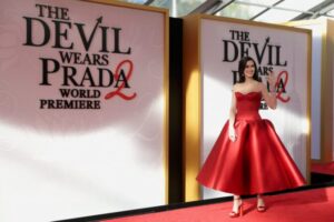 "Anne Hathaway Dazzles in Stunning Red Satin Gown, Showcasing Impressive Cleavage and Curves on the Red Carpet" 6