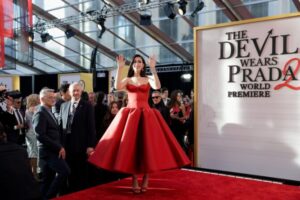 "Anne Hathaway Dazzles in Stunning Red Satin Gown, Showcasing Impressive Cleavage and Curves on the Red Carpet" 7