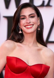"Anne Hathaway Dazzles in Stunning Red Satin Gown, Showcasing Impressive Cleavage and Curves on the Red Carpet" 15