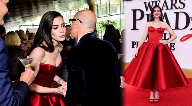 "Anne Hathaway Dazzles in Stunning Red Satin Gown, Showcasing Impressive Cleavage and Curves on the Red Carpet"