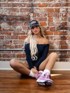 "Brooklyn Riley Stuns in Figure-Hugging Black Bodysuit Paired with Trendy Pink Jordans" 4
