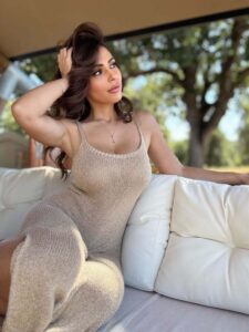 "Maddalena Cabizzosu Dazzles in Shimmering Gold Knit, Showcasing Stunning Cleavage" 5