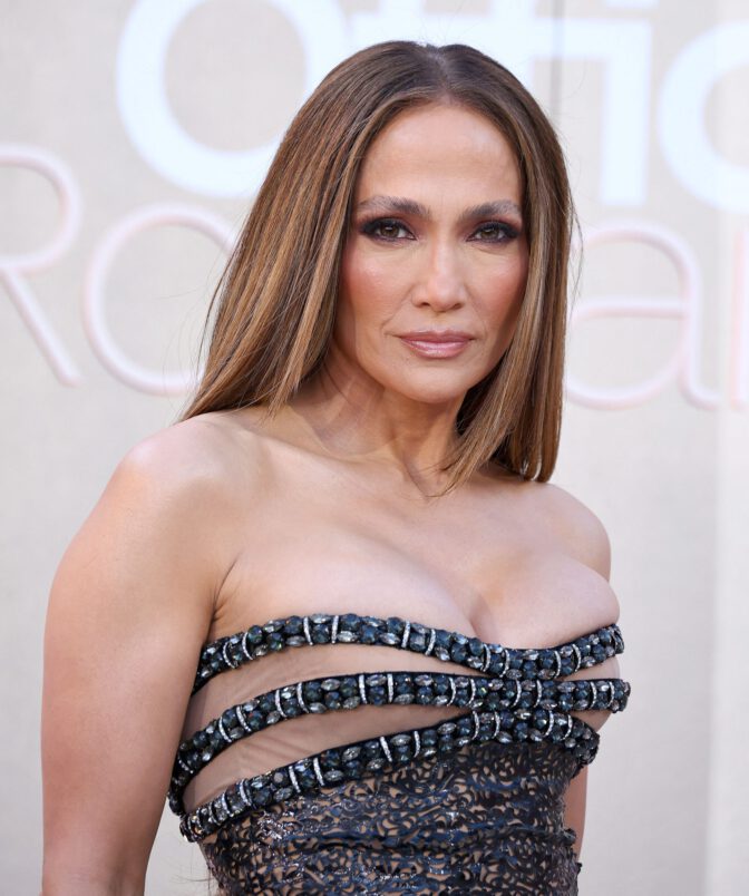 Jennifer Lopez Dazzles in Sheer Gown, Showcasing Stunning Cleavage at Office Romance Premiere