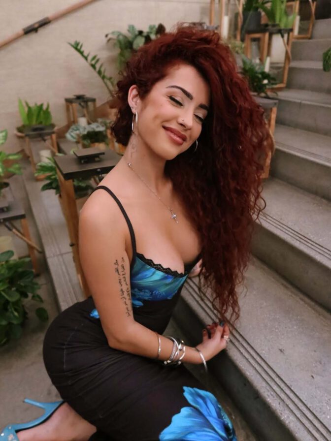 Malu Trevejo Showcases Stunning Curves and Bold Cleavage in Form-Fitting Lace Dress