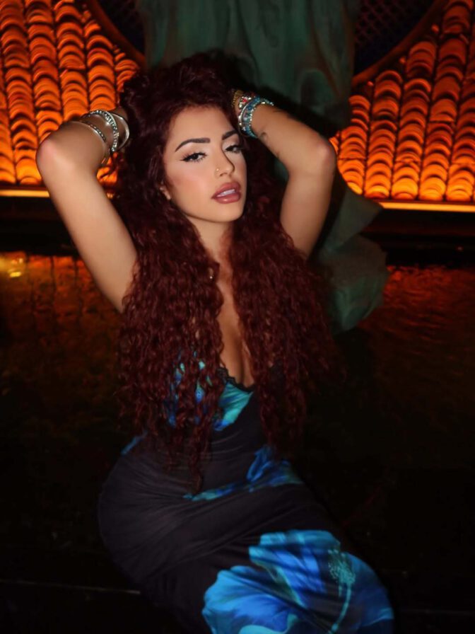 Malu Trevejo Showcases Stunning Curves and Bold Cleavage in Form-Fitting Lace Dress