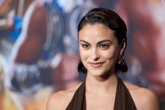 Camila Mendes Stuns in Daring Plunging Brown Halter Gown at Masters of the Universe Premiere