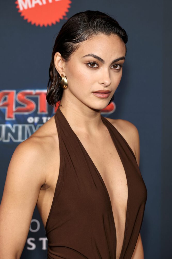 Camila Mendes Stuns in Daring Plunging Brown Halter Gown at Masters of the Universe Premiere