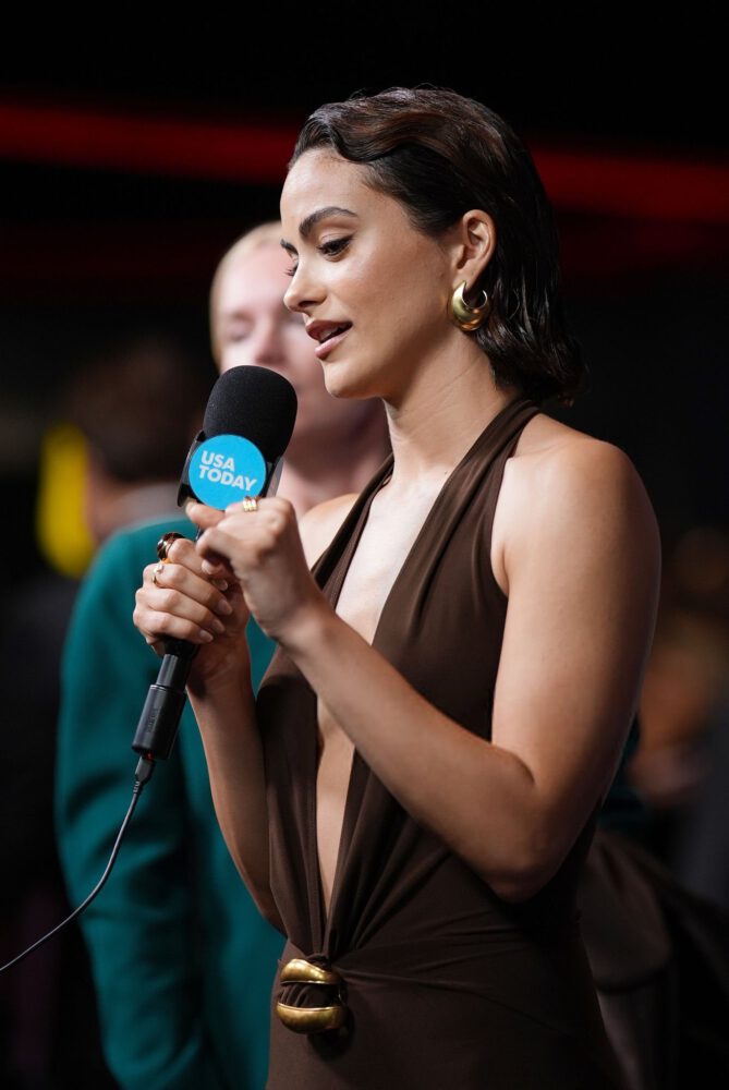 Camila Mendes Stuns in Daring Plunging Brown Halter Gown at Masters of the Universe Premiere
