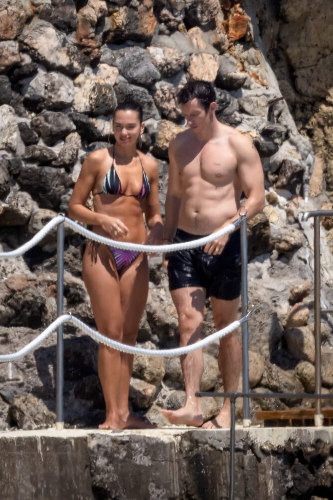 Dua Lipa Exposes Her Nude Tits and Bare Ass on a Rocky Beach with Callum Turner in a Sizzling Topless Display