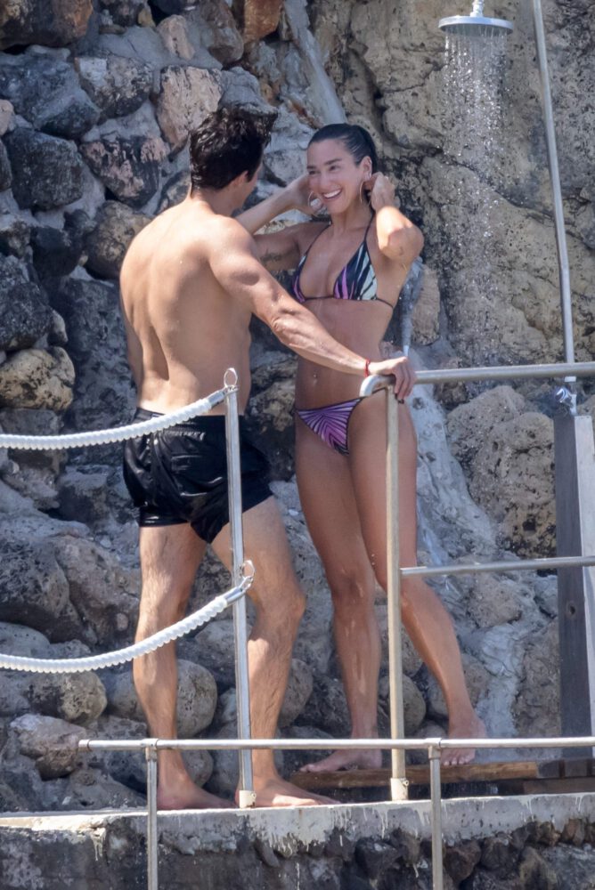Dua Lipa Exposes Her Nude Tits and Bare Ass on a Rocky Beach with Callum Turner in a Sizzling Topless Display