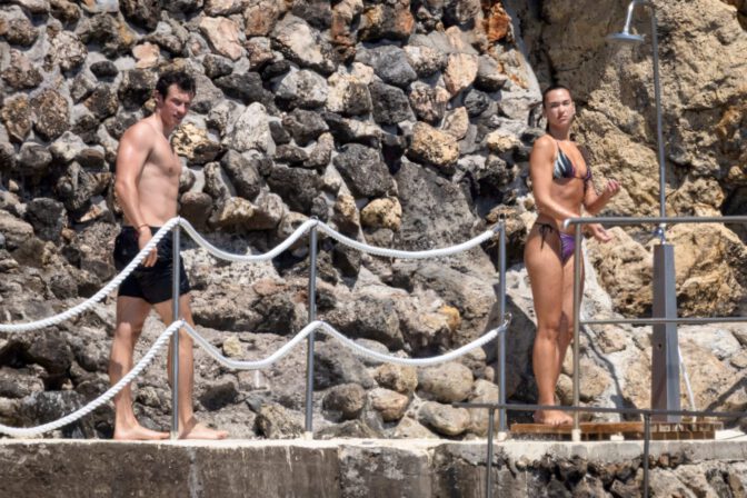 Dua Lipa Exposes Her Nude Tits and Bare Ass on a Rocky Beach with Callum Turner in a Sizzling Topless Display
