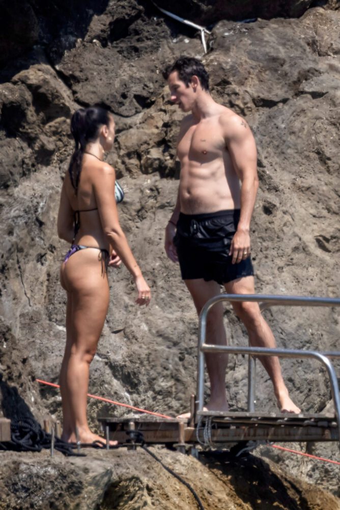 Dua Lipa Exposes Her Nude Tits and Bare Ass on a Rocky Beach with Callum Turner in a Sizzling Topless Display