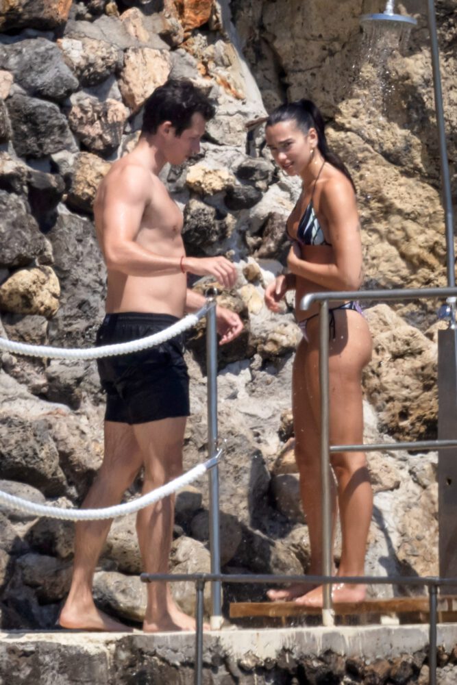 Dua Lipa Exposes Her Nude Tits and Bare Ass on a Rocky Beach with Callum Turner in a Sizzling Topless Display