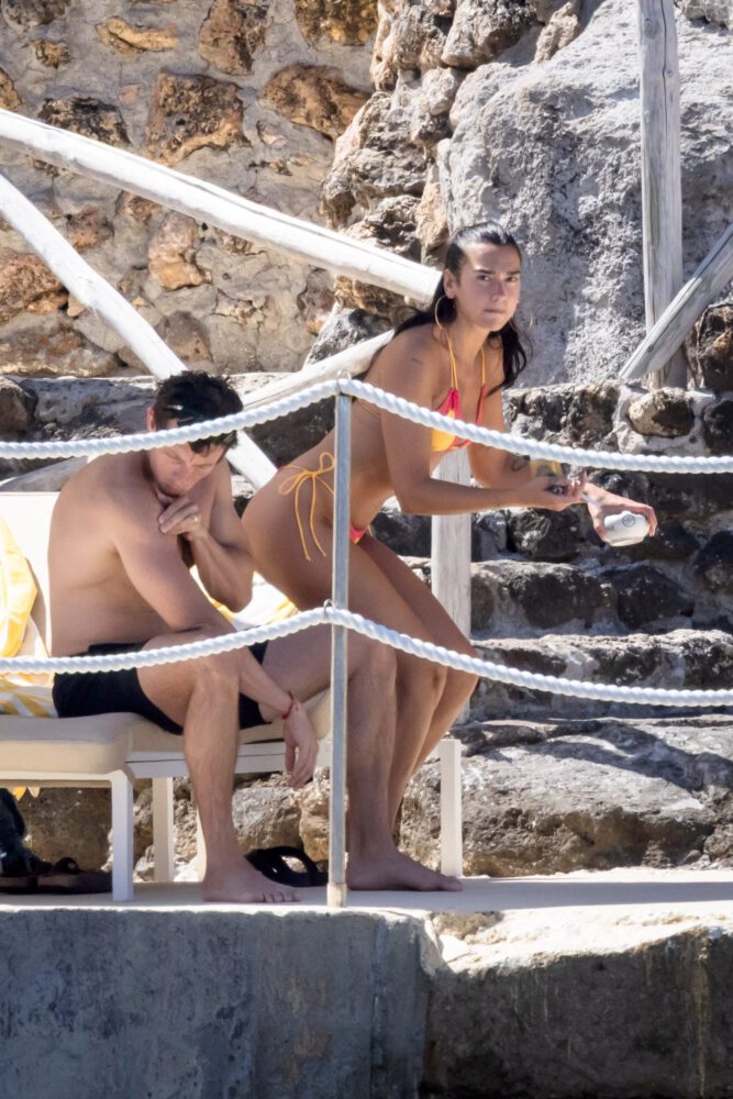 Dua Lipa Sizzles in Minuscule Yellow Bikini Exposing Her Curvy Ass During Sizzling Italian Vacation