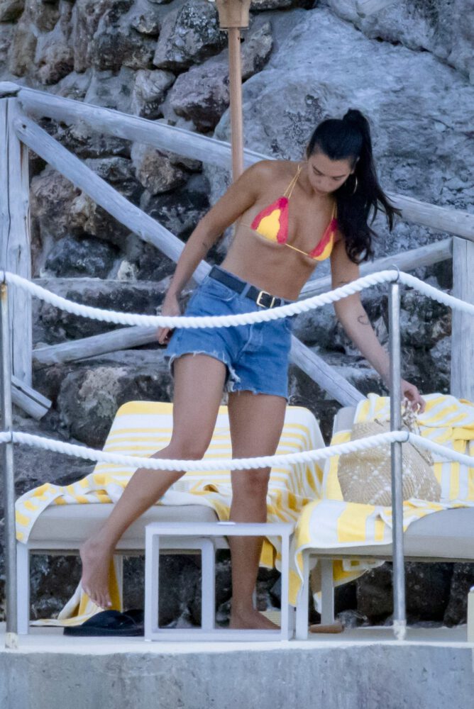 Dua Lipa Sizzles in Minuscule Yellow Bikini Exposing Her Curvy Ass During Sizzling Italian Vacation