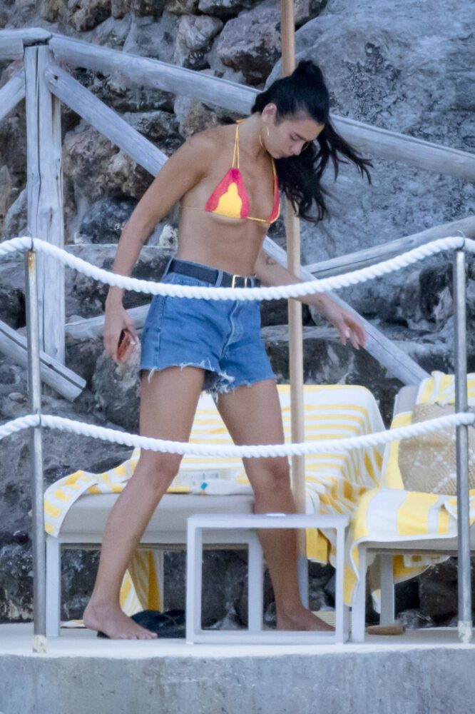 Dua Lipa Sizzles in Minuscule Yellow Bikini Exposing Her Curvy Ass During Sizzling Italian Vacation