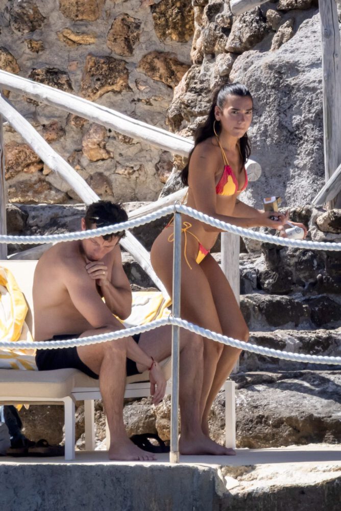Dua Lipa Sizzles in Minuscule Yellow Bikini Exposing Her Curvy Ass During Sizzling Italian Vacation