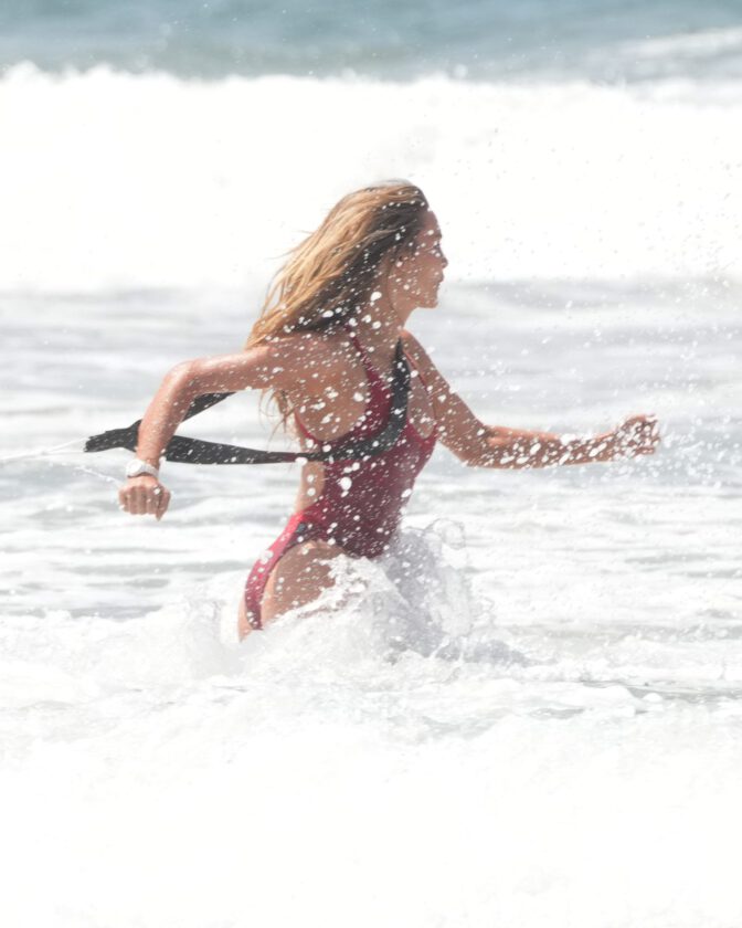 Hassie Harrison Sizzles in Drenched Baywatch Swimsuit Exposing Voluptuous Boobs and Sultry Booty