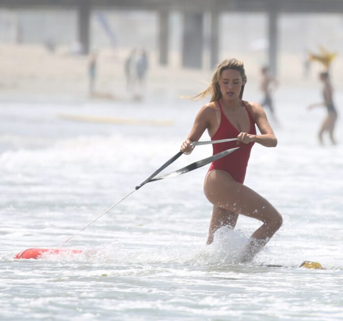 Hassie Harrison Sizzles in Drenched Baywatch Swimsuit Exposing Voluptuous Boobs and Sultry Booty