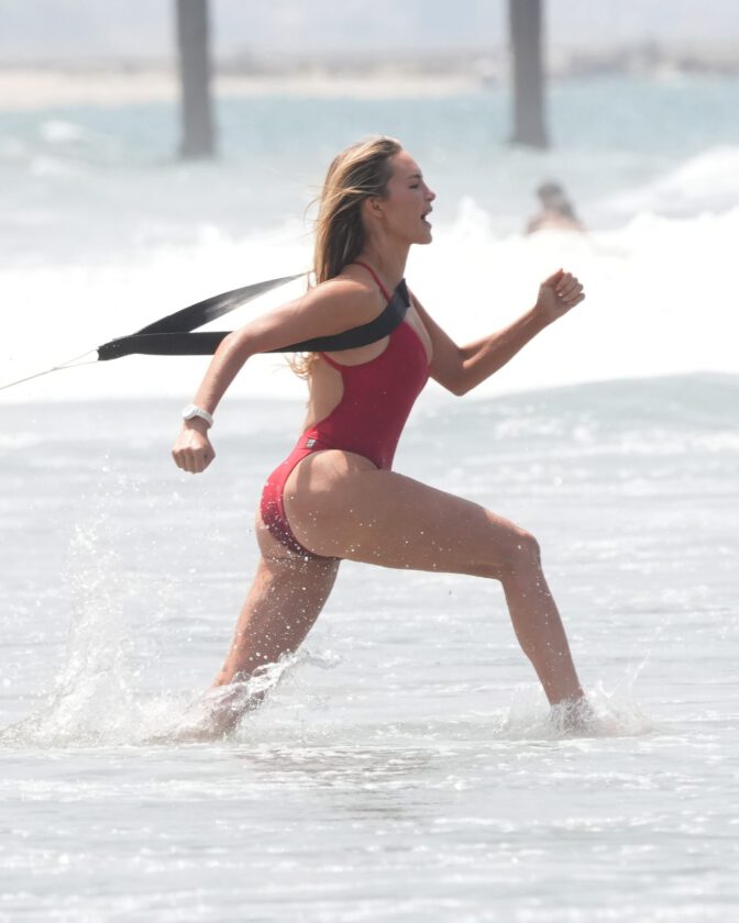 Hassie Harrison Sizzles in Drenched Baywatch Swimsuit Exposing Voluptuous Boobs and Sultry Booty
