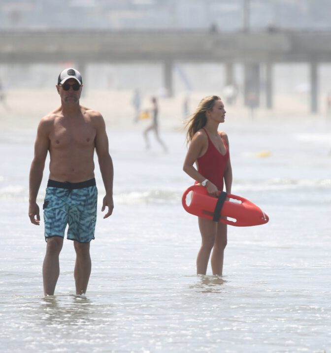 Hassie Harrison Sizzles in Drenched Baywatch Swimsuit Exposing Voluptuous Boobs and Sultry Booty