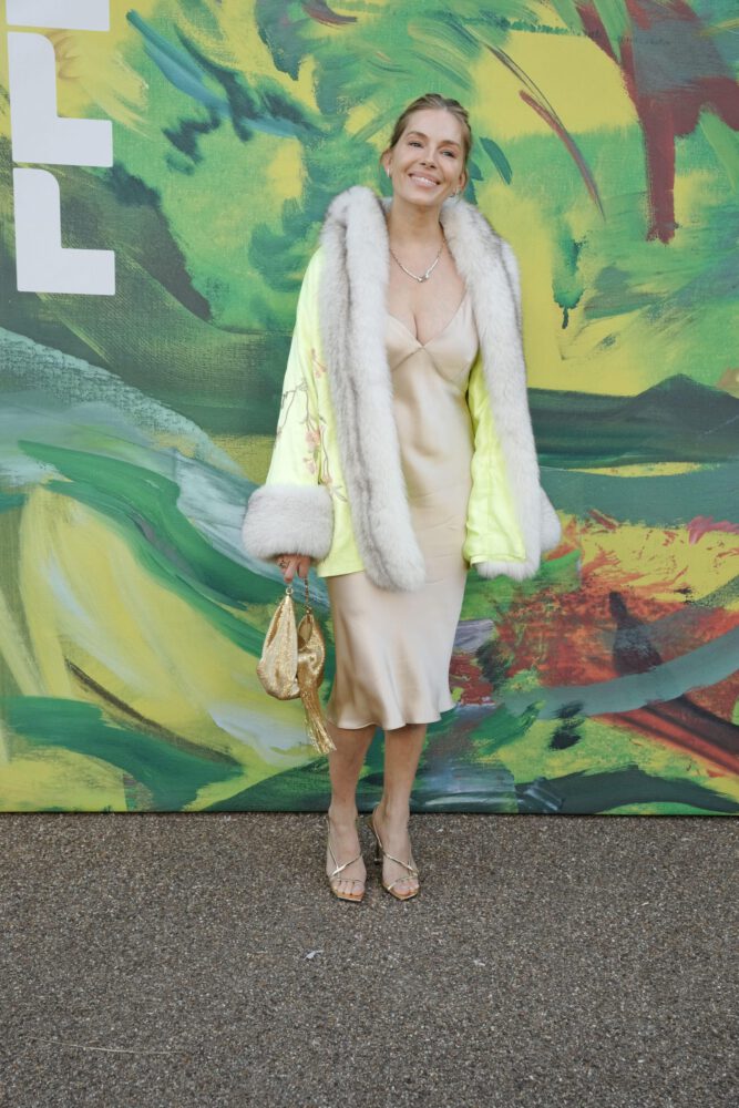 Sienna Miller Flaunts Her Voluptuous Boobs in a Sultry Fur and Silk Ensemble that Exposes Her Sexy Cleavage to the Fullest