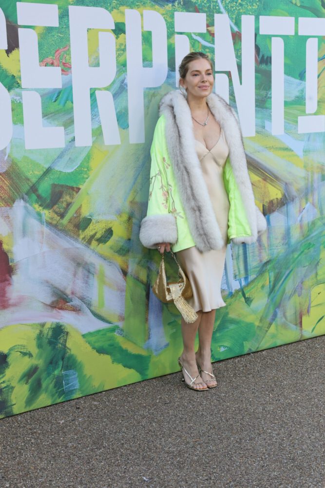 Sienna Miller Flaunts Her Voluptuous Boobs in a Sultry Fur and Silk Ensemble that Exposes Her Sexy Cleavage to the Fullest